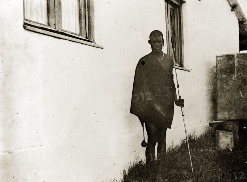 Kenyan 'hunter', Nairobi. Portrait of a traditionally dressed Kenyan man, originally identified as a 'hunter', armed with a spear. Nairobi, British East Africa (Kenya), 1906. Nairobi, Nairobi Area, Kenya, Eastern Africa, Africa.