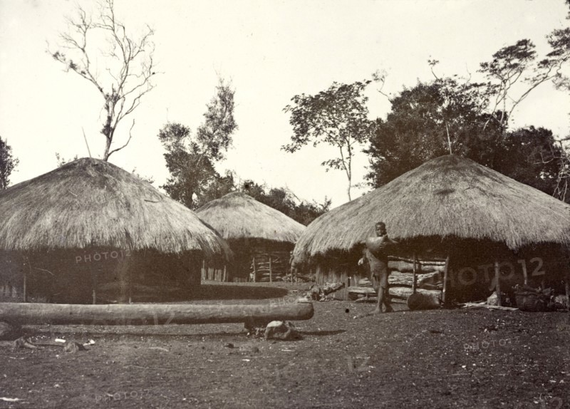 Thatched village huts, Kikuyu. Several round huts with thatched roofs are built closely together in a village. Kikuyu, British East Africa (Kenya), 1906. Kenya, Eastern Africa, Africa.
