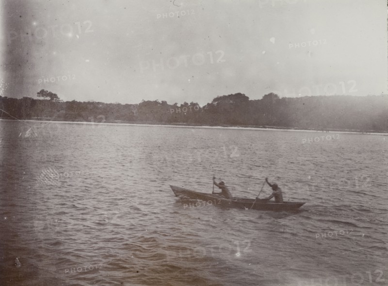 Canoe on Lake Victoria. Two men paddle a small wooden canoe on Lake Victoria. Lake Victoria, British East Africa (Kenya), 1906., Nyanza, Kenya, Eastern Africa, Africa.