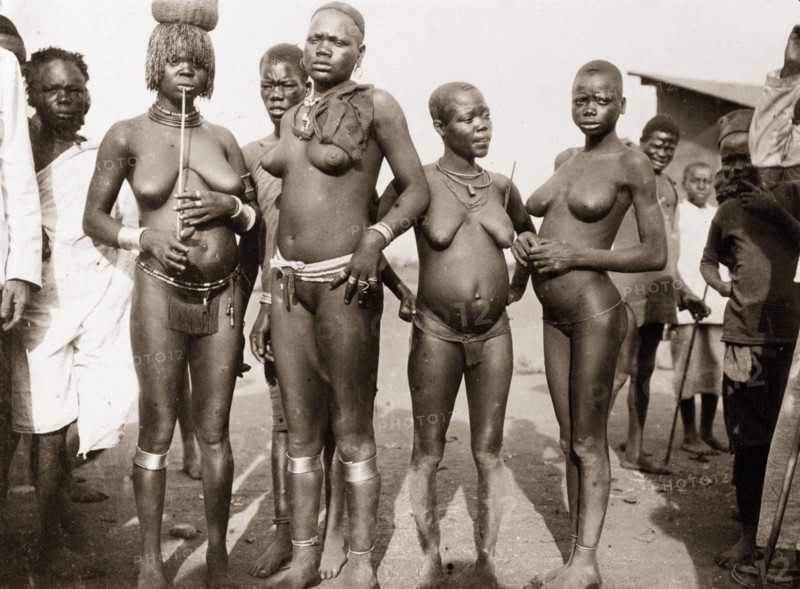 Luo women at Kisumu. Portrait of four nearly naked Luo women at a local market. Kisumu, British East Africa (Kenya), 1906. Kenya, Eastern Africa, Africa.