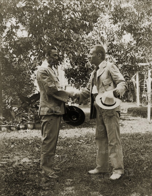 Directors of Anglo-Siamese Boundary Demarcation shake hands. Phya Suntara, Siamese Commissioner, shakes hands with Carlo Ferdinando Bozzolo, British District Magistrate. Janing, British Malaya (Malaysia), December 1901. Janing, Perak, Malaysia, South East Asia, Asia.