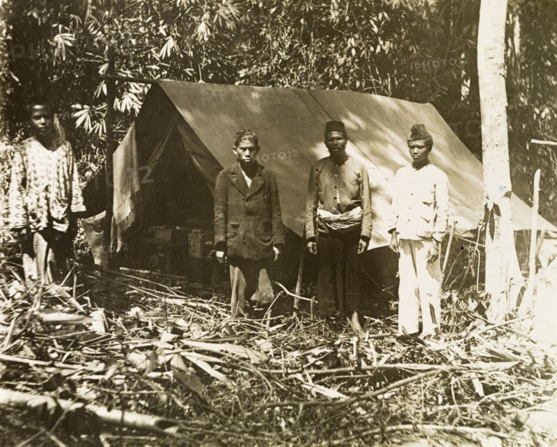 Malay surveying assistants. Malay assistants outside a camp on a British-led trigonometrical survey. Probably in northern Perak, British Malaya (Malaysia), circa 1901., Perak, Malaysia, South East Asia, Asia.