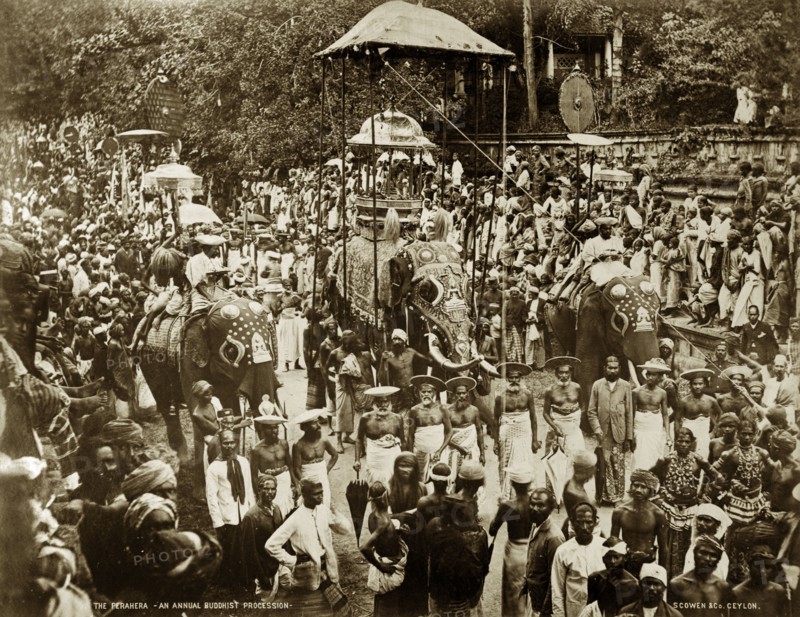 Buddist perahera in Ceylon. Crowds of people pack the streets at an annual Buddhist perahera (procession) in honour of the Sacred Relic of the Buddha's Tooth. The procession is headed by three decorated elephants. Kandy, Ceylon (Sri Lanka), circa 1885. Kandy, Central (Sri Lanka), Sri Lanka, Southern Asia, Asia.