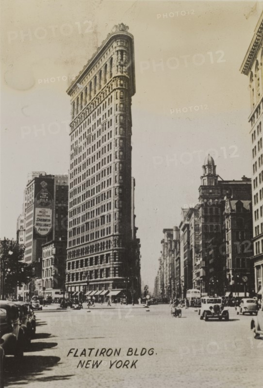 Flatiron Building. Ground level view of the Flatiron building, located on the corner of 23rd Street, Fifth Avenue and Broadway. New York, United States of America, circa 1942. New York, New York, United States of America, North America, North America .