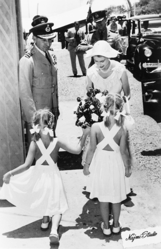 Queen Elizabeth II presented with flowers by two girls in Aden, 1954. Two young girls present a bouquet of flowers to Queen Elizabeth II, during her visit to Aden as part of a royal tour of the Commonwealth from November 1953 to May 1954. Aden, Yemen, 27 April 1954. Aden, Adan, Yemen, Middle East, Asia.