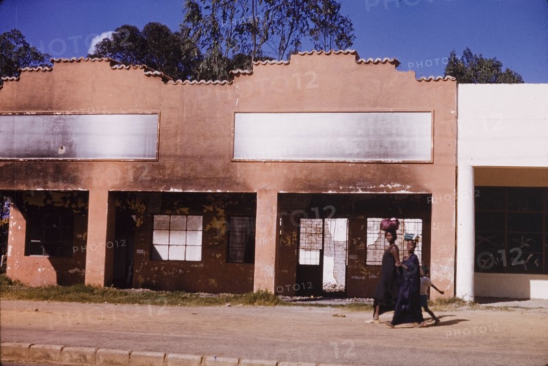 Commercial building damaged in riots, Elizabethville. A burnt and gutted commercial building in Elizabethville, which was destroyed in riots during the Congolese civil war (1960-63). Elizabethville, Republic of the Congo (Lubumbashi, Democratic Republic of the Congo), circa 1964. Lubumbashi, Haut Katanga, Congo, Democratic Republic of, Central Africa, Africa.
