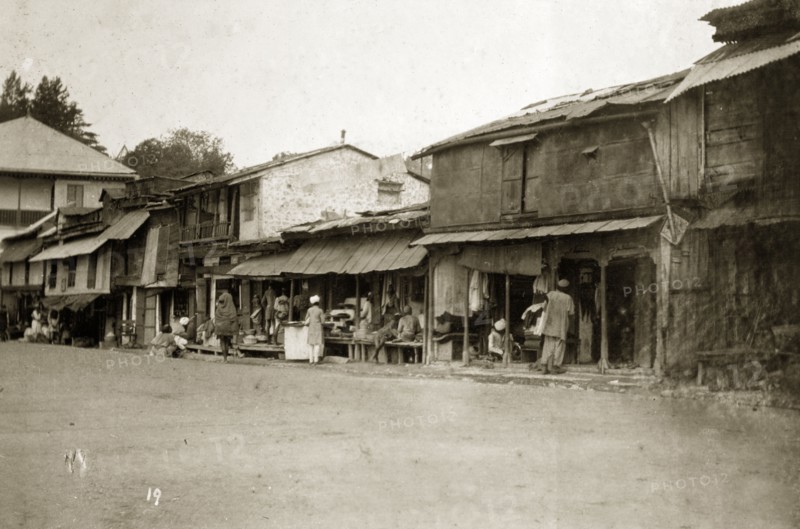 Street traders at a bazaar, India. Street traders at a bazaar sell their wares from ramshackle buildings on the main street of a town. India, 1890. India, Southern Asia, Asia.
