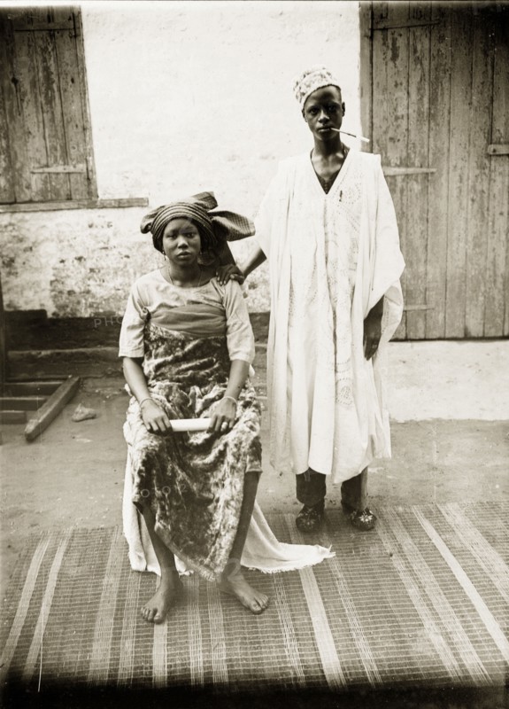 Portrait of a Hausa husband and wife. Portrait of a Hausa husband and wife, posing for the camera in traditional dress. Badagry, Nigeria, circa 1928. Badagry, Lagos, Nigeria, Western Africa, Africa.