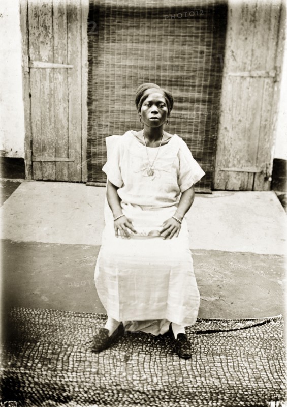 Portrait of a Nigerian woman. Portrait of a Nigerian woman, seated and looking proudly into the camera. Badagry, Nigeria, circa 1928. Badagry, Lagos, Nigeria, Western Africa, Africa.