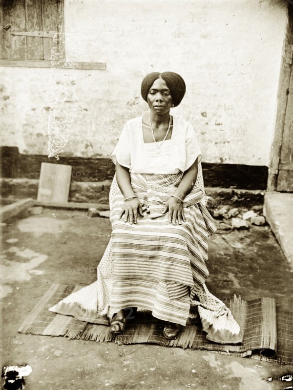 Portrait of a seated Nigerian woman. Portrait of a Nigerian woman, seated and wearing traditional dress. Probably Badagry, Nigeria, circa 1928. Badagry, Lagos, Nigeria, Western Africa, Africa.