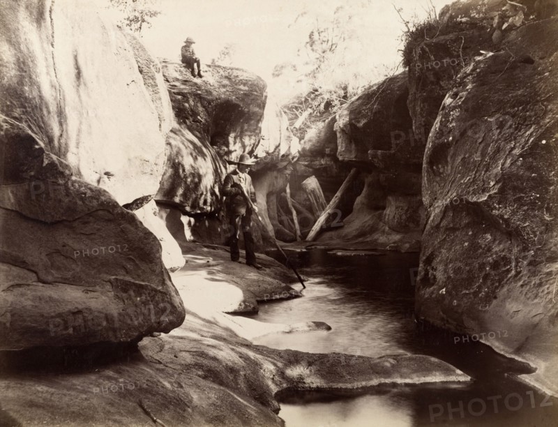 Rock pool, Australia. A man and boy pass time by a rock pool or stream. Possibly New South Wales, Australia, circa 1890. Australia, Australia, Oceania.