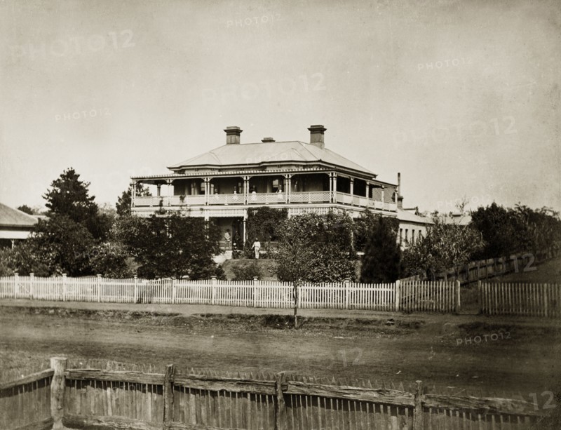House called 'Nundora', Australia. The Brodribb family's home, 'Nundora', probably located on Herries Street. The imposing colonial house, two storeys high is surrounded by a large garden ringed with a picket fence. The house has broad verandas, a sloping roof and multiple chimneys. Toowoomba, Australia, circa 1890. Toowoomba, Queensland, Australia, Australia, Oceania.