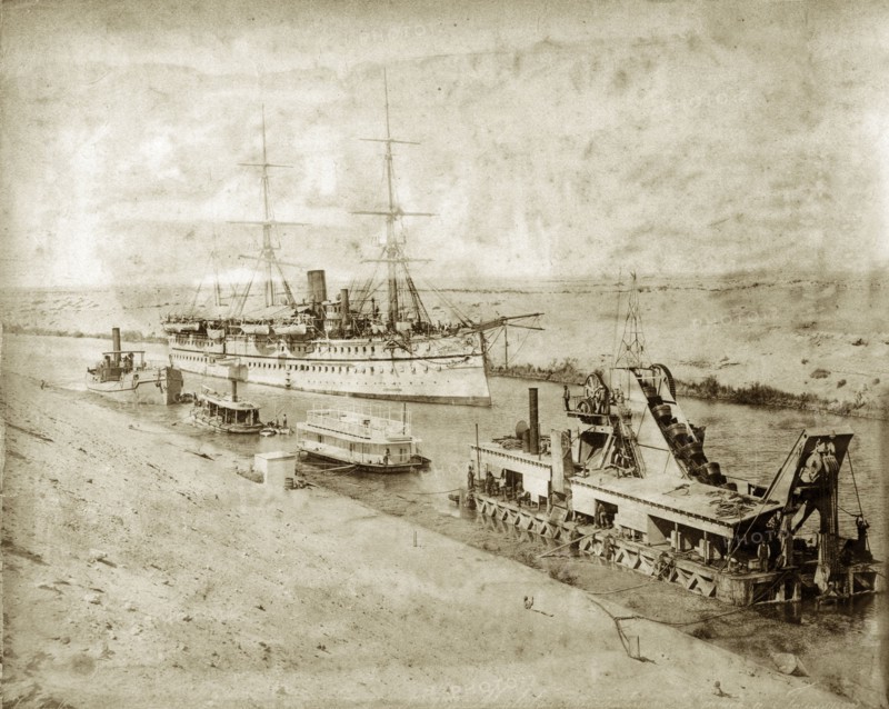 The 'Malabar' in the Suez Canal. HM Indian troopship 'Malabar' in the Suez Canal. A dredger and several small steamers are visible in the foreground. Suez, Egypt, circa 1893. Suez, Suez, Egypt, Northern Africa, Africa.