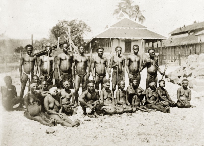 Andaman Islanders. Outdoors portrait of a group of semi-naked Andaman Islanders. The men in the back row stand with bows and arrows, smoking clay pipes. The women sit or kneel on the ground. Andaman Islands, India, circa 1900., Andaman and Nicobar Islands, India, Southern Asia, Asia.