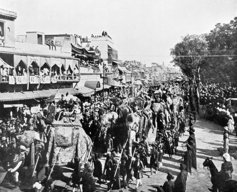 Procession through the Chandni Chowk. Crowds line the Chandni Chowk ('Silver Road') to watch the state entry procession of the Coronation Durbar. British dignitaries and Indian Maharajahs ride in howdahs on the backs of bejewelled elephants, amongst them Lord and Lady Curzon and the Duke and Duchess of Connaught. Delhi, India, 29 December 1902. Delhi, Delhi, India, Southern Asia, Asia.