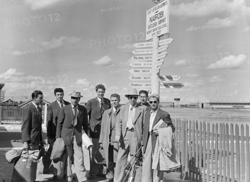 French athletics team. Members of a French athletics team pose beneath a signpost on their arrival at Eastleigh airport. Nairobi, Kenya, 9 November 1952. Nairobi, Nairobi Area, Kenya, Eastern Africa, Africa.