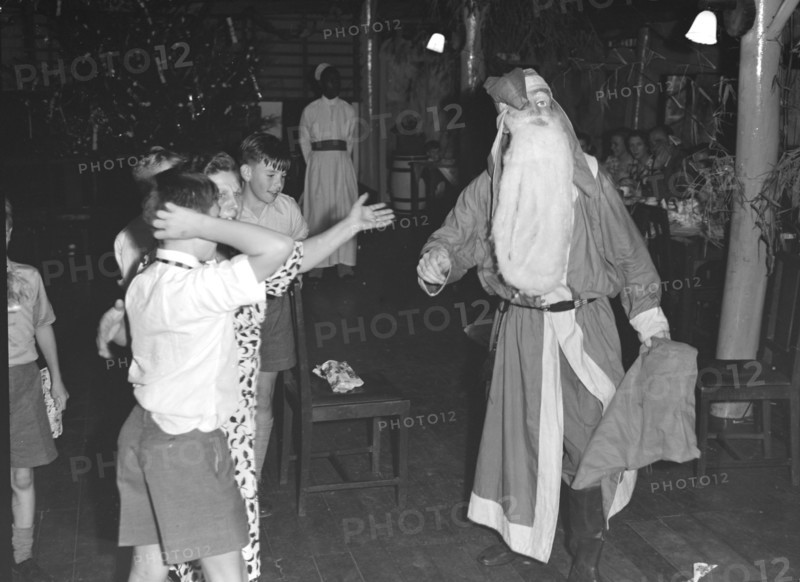 Father Christmas visits. Father Christmas visits a children's Christmas party at the Forest Inn. Possibly Nairobi, Kenya, 25 December 1952. Kenya, Eastern Africa, Africa.