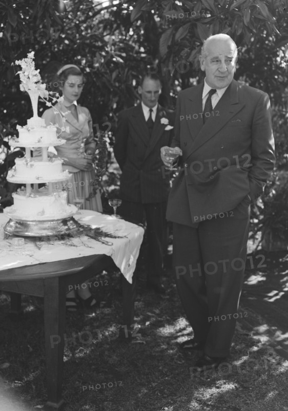 Wedding speech. A middle-aged gentleman delivers the first of the speeches, drink in hand, at the Wendy Allen-Dudley Winter wedding. Kenya, 30 December 1952. Kenya, Eastern Africa, Africa.