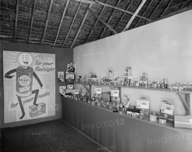 Berec batteries. Interior shot of the Berec stand at the Royal Show, headed by a large poster advertising Berec batteries 'for your flashlight and radio'.
Kenya 25 September 1957. Kenya, Eastern Africa, Africa.