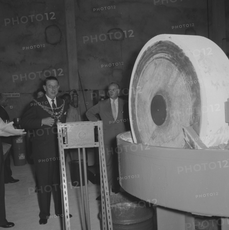 Leyland Paint Factory. A Mayor, dressed in a suit and ceremonial chain, prepares to start machinery at the opening of a new Leyland Paint Factory. Kenya, 12 October 1957. Kenya, Eastern Africa, Africa.