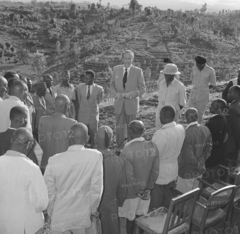Lennox-Boyd visits Fort Hall. Alan Tindal Lennox-Boyd (1904-1983) meets Kenyan elders of the Fort Hall district, guided by Chief Ignatio who stands by his side wearing a solatopi hat. Fort Hall, Kenya, 15 October 1957., Central (Kenya), Kenya, Eastern Africa, Africa.