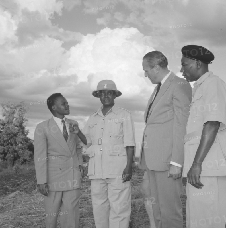 Lennox-Boyd visits Fort Hall. Alan Tindal Lennox-Boyd (1904-1983) visits the Fort Hall district, guided by Chief Ignatio, the central figure in the solatopi hat. Fort Hall, Kenya, 15 October 1957., Central (Kenya), Kenya, Eastern Africa, Africa.