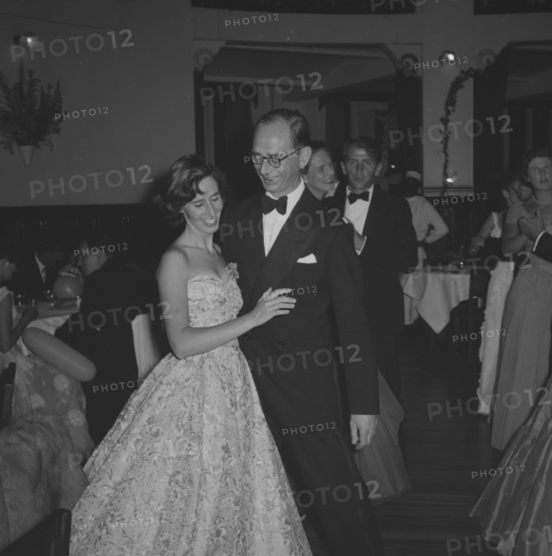 Guests at the Limuru Hunt Ball. A formally dressed couple share a private joke on the dance floor at the Limuru Hunt Ball. Kenya, 19 October 1957. Kenya, Eastern Africa, Africa.