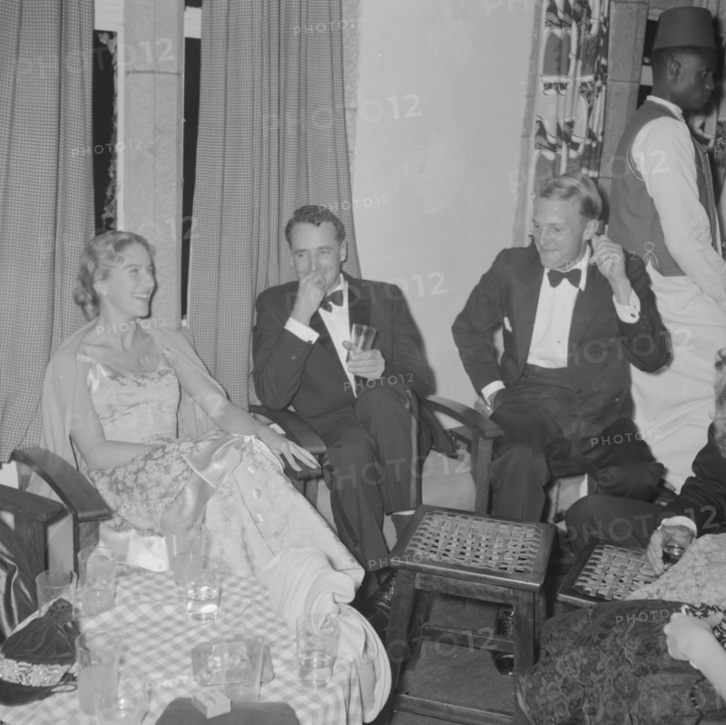 Orme-Smith 21st birthday party. A group of formally dressed young adults joke together at the Orme-Smith 21st birthday party. Kenya, 9 November 1957. Kenya, Eastern Africa, Africa.
