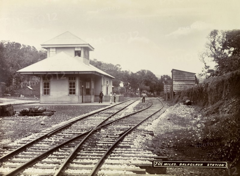Balaclava railway station. A group of men loiter on the platform and track outside Balaclava railway station. Balaclava, Jamaica, circa 1895. Balaclava, St Elizabeth, Jamaica, Caribbean, North America .