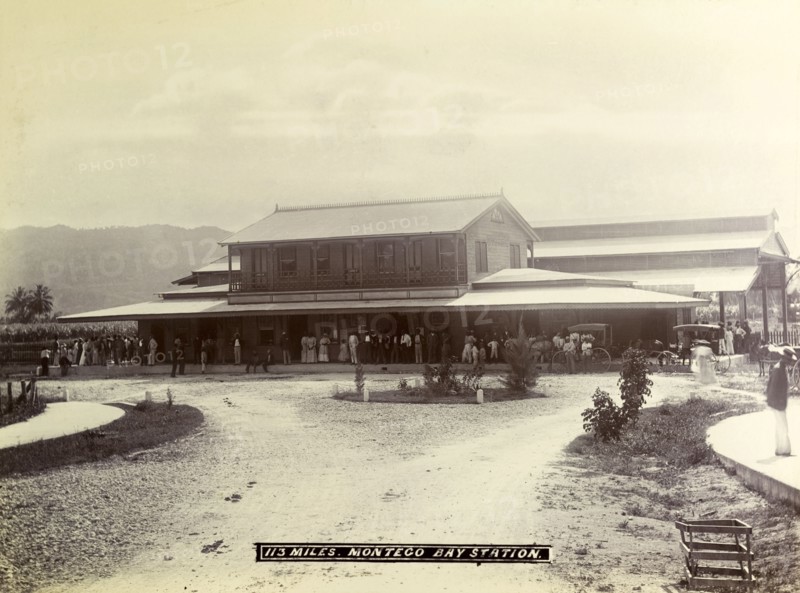 Montego Bay railway station. A crowd of passengers waits on the veranda outside Montego Bay station. Montego Bay, Jamaica, circa 1895. Montego Bay, St James (Jamaica), Jamaica, Caribbean, North America .