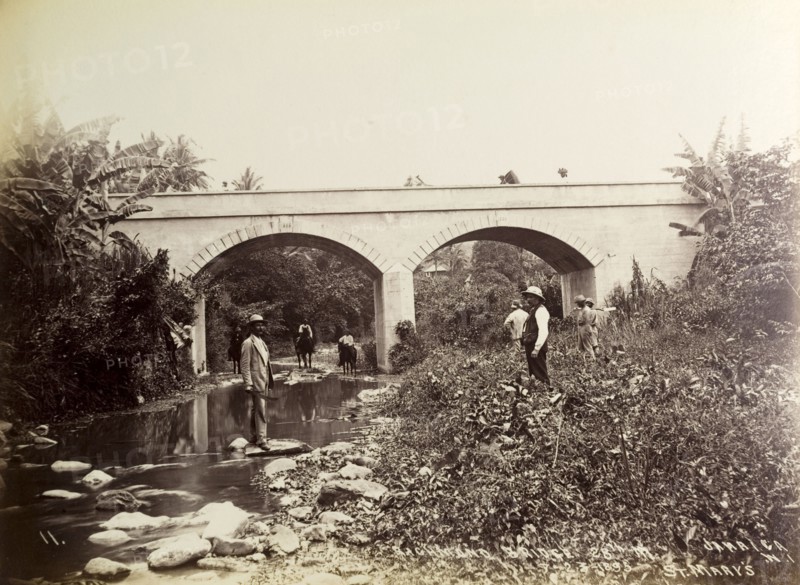 Richmond Bridge, Jamaica. Several people mill about on the banks of a shallow river beneath the arches of Richmond Bridge. St Mary, Jamaica, 23 July 1893., St Mary (Jamaica), Jamaica, Caribbean, North America .