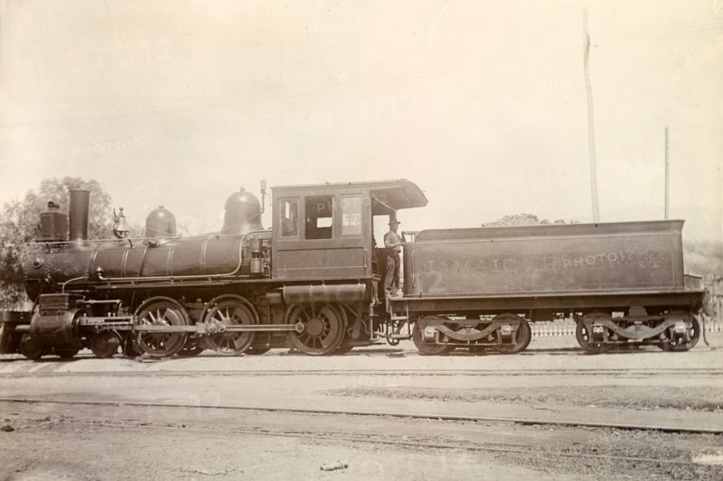 American steam locomotive, Jamaica. An American-manufactured steam locomotive sits on rails at a siding. Jamaica, circa 1895. Jamaica, Caribbean, North America .