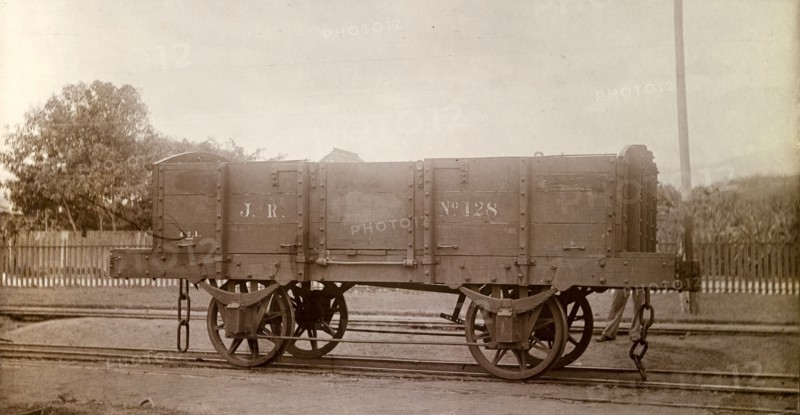 Jamaica Railway wagon. An open railway wagon inscribed 'J.R. No.128', sits on rails at a siding. Jamaica, circa 1895. Jamaica, Caribbean, North America .