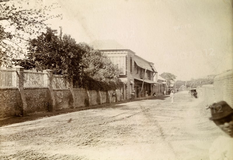 Kingston tram lines. Rails laid down for mule-drawn trams stretch into the distance along a long, empty road. Kingston, Jamaica, circa 1895. Kingston, Kingston, Jamaica, Caribbean, North America .