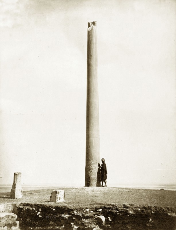 The Ashoka Pillar, Delhi. A lone figure stands beside the ancient Buddhist Ashoka Pillar. Delhi, India, circa 1880., Delhi, India, Southern Asia, Asia.