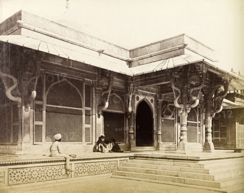 Salim Chisti's tomb. Two figures sit outside the entrance to Salim Chisti's tomb, built in 1570 during the reign of Mughal Emperor Akbar (r.1556-1605). Fatehpur Sikri, North Western Provinces (Uttar Pradesh), India, circa 1885. Fatehpur Sikri, Uttar Pradesh, India, Southern Asia, Asia.