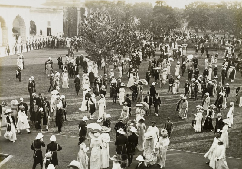 Coronation Durbar garden party. Formally dressed guests socialise on the lawns outside the Delhi Fort at a garden party held for King George V's Coronation Durbar. Delhi, India, circa 13 December 1911. Delhi, Delhi, India, Southern Asia, Asia.
