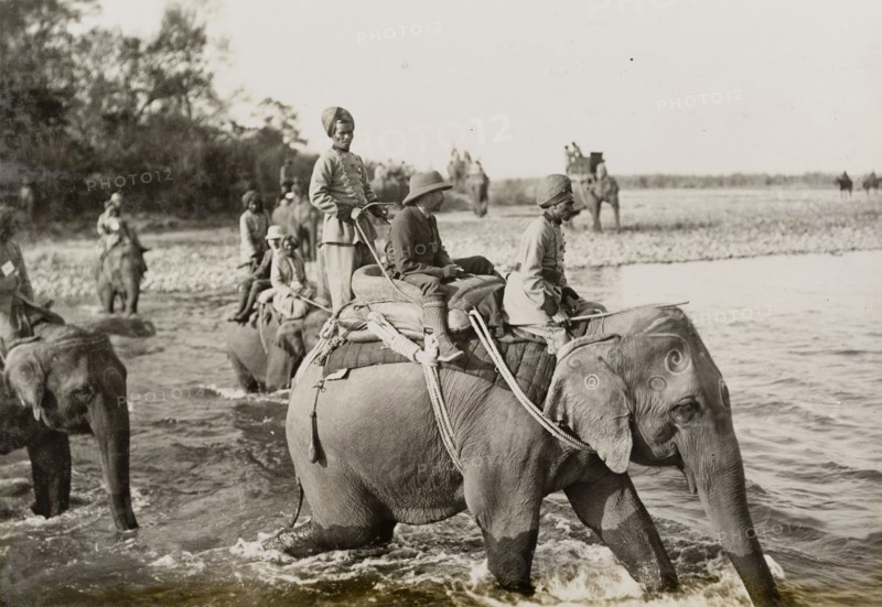 King George V crosses a river. King George V (r.1910-36) crosses a river on the back of an elephant during a royal hunt hosted by the Maharajah of Nepal. The King travelled to Nepal to hunt in Chitwan Valley following his Coronation Durbar in Delhi. Narayani, Nepal, circa 20 December 1911., Narayani, Nepal, Southern Asia, Asia.
