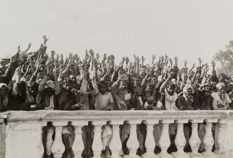 A loyal greeting for King George V's visit. An Indian crowd waves in greeting to a royal train carrying King George V from the Coronation Durbar in Delhi to Nepal. Probably United Provinces (Uttar Pradesh), Northern India, circa 15 December 1911., Uttar Pradesh, India, Southern Asia, Asia.