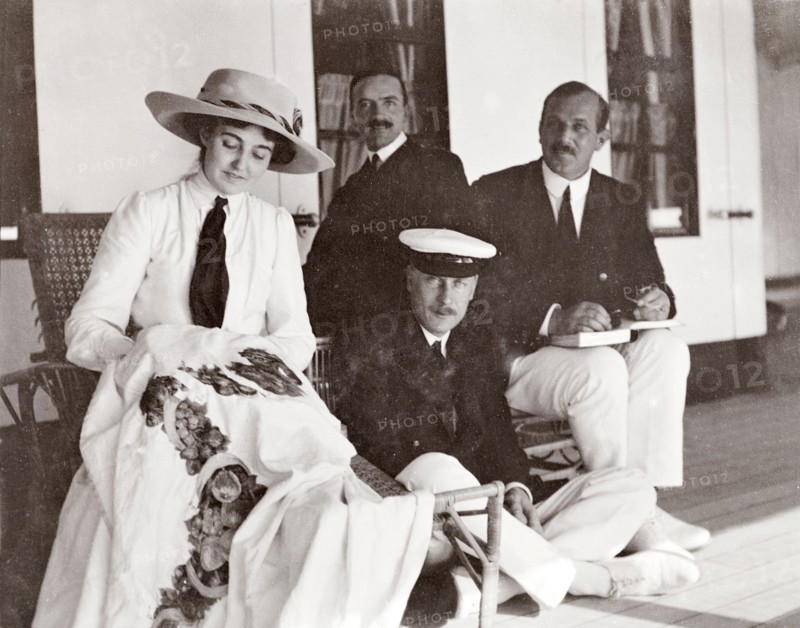 Princess Patricia on the S.S. Balmoral. Accompanied by three men from the royal entourage, Princess Patricia, daughter of the Duke of Connaught, embroiders a tablecloth on the deck of the S.S. Balmoral Castle. She was travelling with her parents who were due to open the new Union Parliament at Cape Town. Probably Atlantic Ocean, Africa, October 1910. Africa.