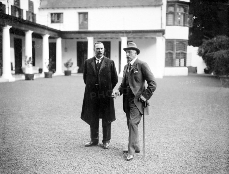 Duke of Connaught visits Bloemfontein. The Duke of Connaught (right) stands talking with a European dignitary in the driveway outside a colonial building. This was one of several stops made by the Duke following his official visit to Cape Town to open the new Union Parliament. Bloemfontein, Orange Free State (Free State), South Africa, 9 November 1910. Bloemfontein, Free State, South Africa, Southern Africa, Africa.
