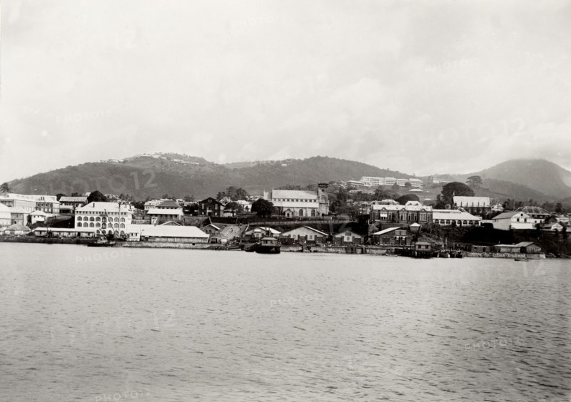 Coastal town in southern Africa. View of an unidentified coastal town surrounded by mountains. The photograph was taken during the Duke of Connaught's official tour of southern Africa, which culminated in the opening of the new Union Parliament at Cape Town. Southern Africa, circa 18 November 1910., Southern Africa, Africa.