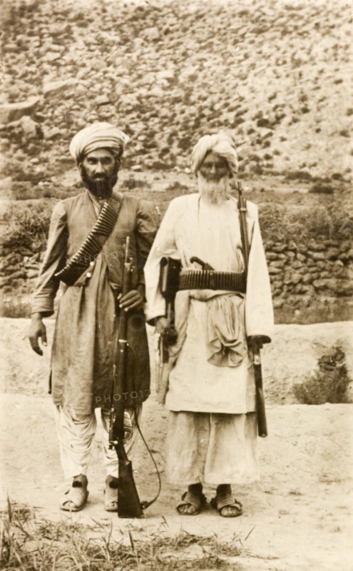 Armed Afridi men. Portrait of two Afridi men at the north west frontier, both armed with rifles and belts of bullets. An original caption comments: 'An example of tribesmen, with their modern rifles, most probably stolen'. North West Frontier Province, India (Pakistan), circa 1915., North West Frontier Province, Pakistan, Southern Asia, Asia.