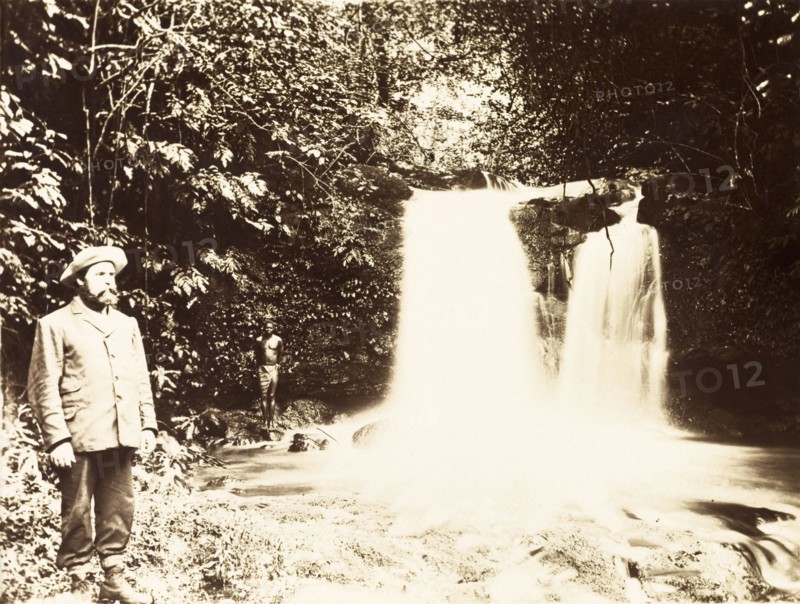 A British missionary on Bioko. A British Primitive Methodist missionary stands pensively beside a jungle waterfall. Bioko, Equatorial Guinea, circa 1930., Bioko Norte, Equatorial Guinea, Central Africa, Africa.
