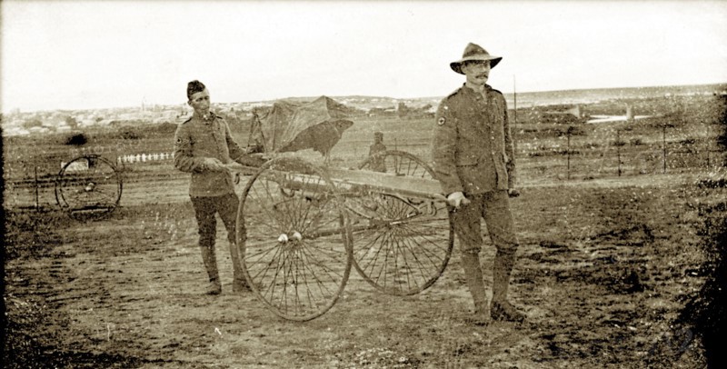 Boer War stretcher-bearers. Two uniformed stretcher-bearers in the British Army carry an empty, wheeled stretcher across a muddy battlefield during the Second Boer War (1899-1902). The man on the left appears to be Indian, and may have been one of thousands of Indian Army officers shipped to South Africa to help the British fight the Boers. South Africa, circa 1900. South Africa, Southern Africa, Africa.