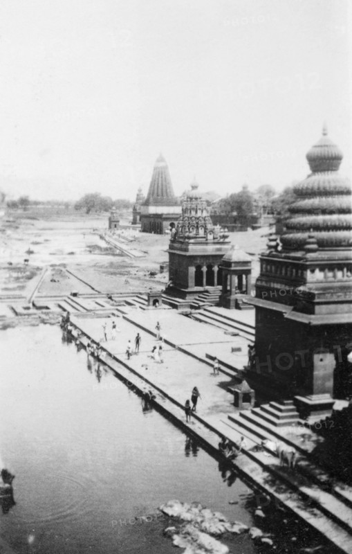 Pilgrims bathing at Wai. Religious pilgrims bathe in the shadows of ornate temples on the River Krishna. Wai, Maharashtra, India, circa 4 June 1926. Wai, Maharashtra, India, Southern Asia, Asia.