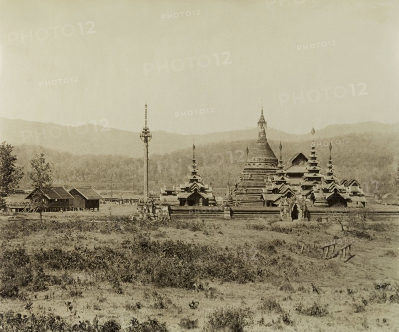 The 'Pon-gyi kyaunga' at Wuntho. View of the 'Pon-gyi kyaunga' (Buddhist monastery) at Wuntho. A telegraph pole stands to the left of the complex beside two wooden buildings identified as the 'post and telegraph offices'. This scene was captured shortly after British forces took control of Wuntho following a conflict with Burmese rebels. Wuntho, Burma (Myanmar), 1891. Wuntho, Sagaing, Burma (Myanmar), South East Asia, Asia.