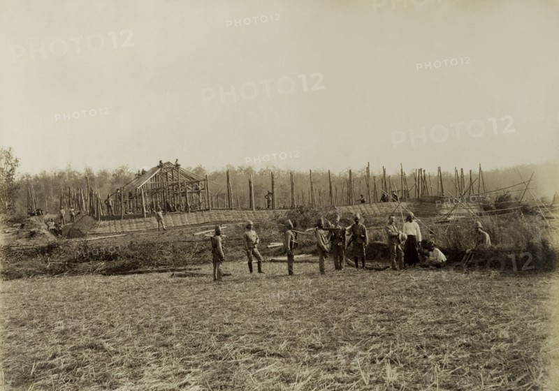 Stockade built by Lieutenant Chapman. British and Indian soldiers pause for the camera during the construction of a stockade overseen by Lieutenant R.E. Chapman. Possibly a mix of British Army and Military Police officers, the men were involved in a campaign to suppress Burmese rebels in Wuntho State (Sagaing Division). Youngma, Burma (Myanmar), 1891. Youngma, Sagaing, Burma (Myanmar), South East Asia, Asia.