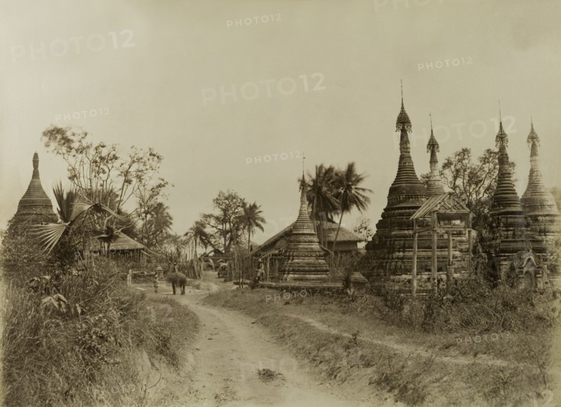 The road into Youngma. The road leading into Youngma, lined with carved stone 'zeidis' or pagodas. This scene was captured during the British campaign to suppress Burmese rebels in Wuntho State (Sagaing Division). Youngma, Burma (Myanmar), circa 1891. Youngma, Sagaing, Burma (Myanmar), South East Asia, Asia.