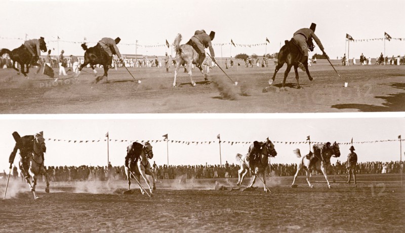 Cavalrymen in a 'tent-pegging' competition. A crowd of onlookers watch as four Sudanese cavalrymen of the Anglo-Egyptian army engage in a 'tent-pegging' competition. 'Tent-pegging' is a traditional cavalry sport that requires the rider to pick up small ground targets using a sword or lance whilst riding at a gallop. Sudan, circa 1910. Sudan, Eastern Africa, Africa.